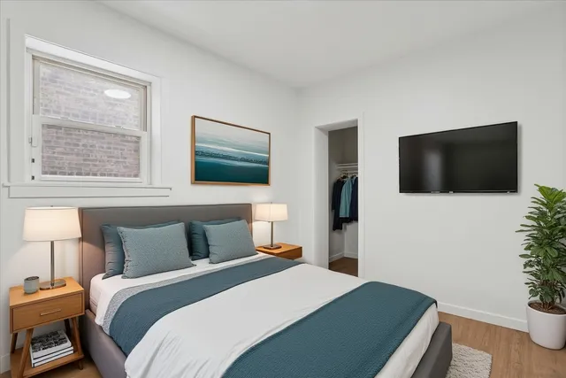 a bedroom with a bed and a flat screen tv