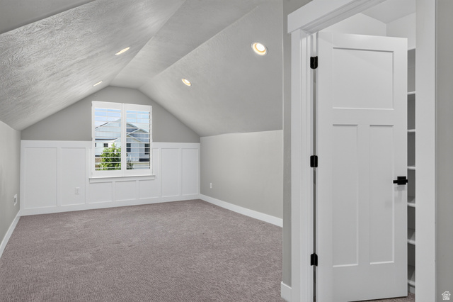 36 West Syracuse Road Vineyard, UT 84059 - Photo 42 of 56 Room featuring an angled ceiling with recessed lighting, board and batten wall detailing, a window with louvered blinds, and gray carpeting