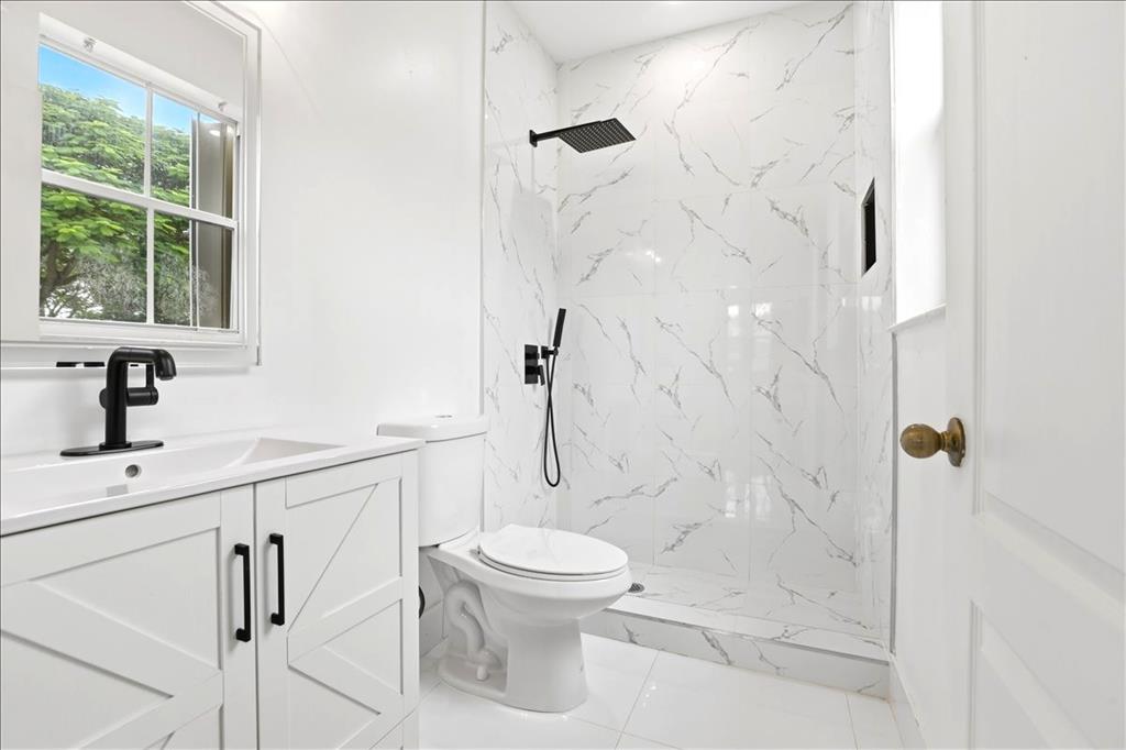 3802 Southwest 165th Terrace Miramar, FL 33027 - Photo 14 of 49 a bathroom with a toilet sink and a shower