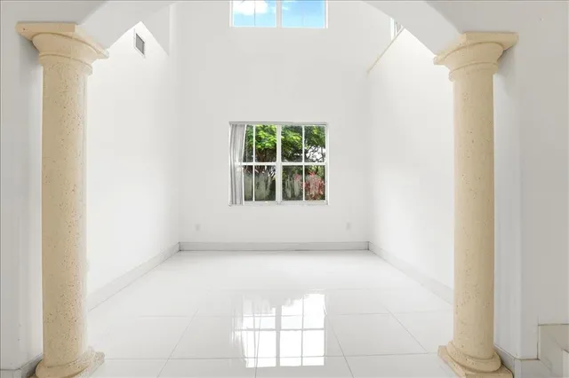 a view of entryway and hall with a front door