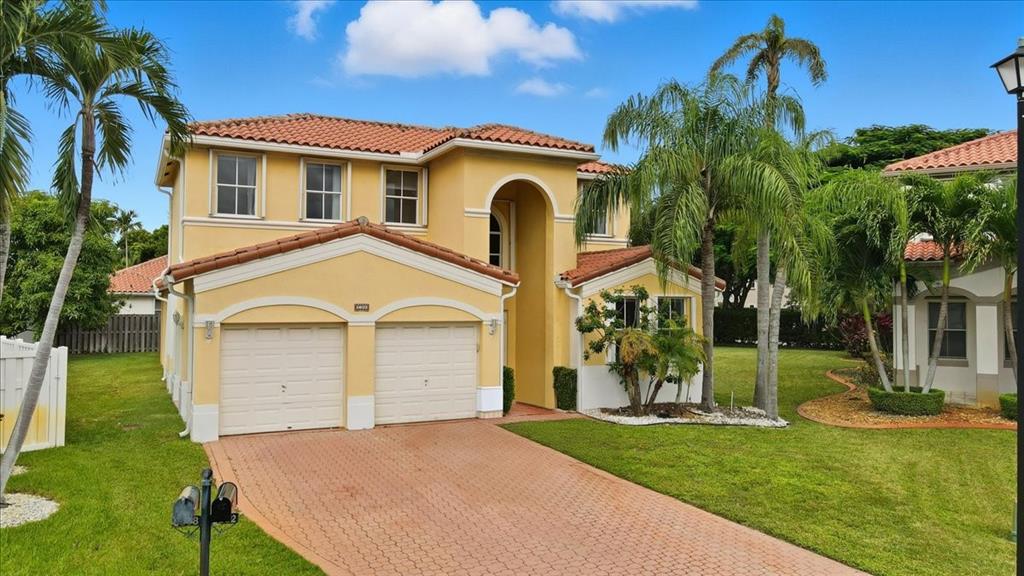 3802 Southwest 165th Terrace Miramar, FL 33027 - Photo 2 of 49 a front view of a house with garden