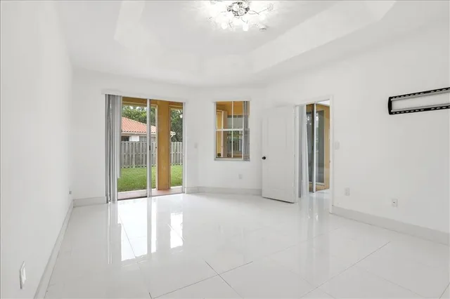 a dining room with kitchen island stainless steel appliances a sink and cabinets