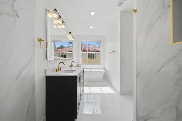 a bathroom with a double vanity sink mirror and shower