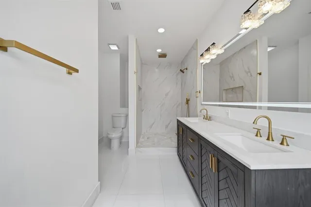 a bathroom with a sink vanity and mirror