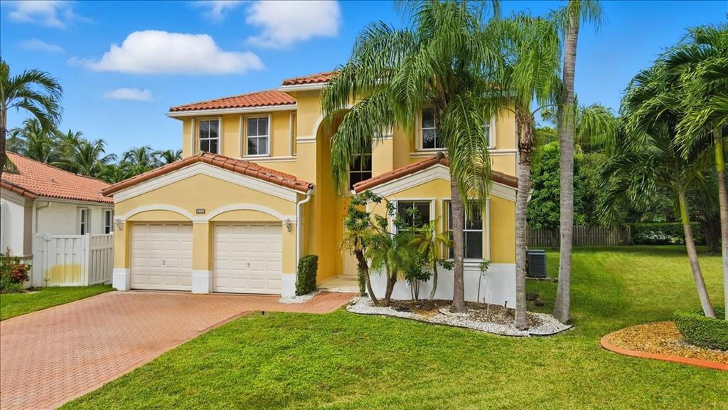 3802 Southwest 165th Terrace Miramar, FL 33027 - Photo 3 of 49 a front view of a house with a yard
