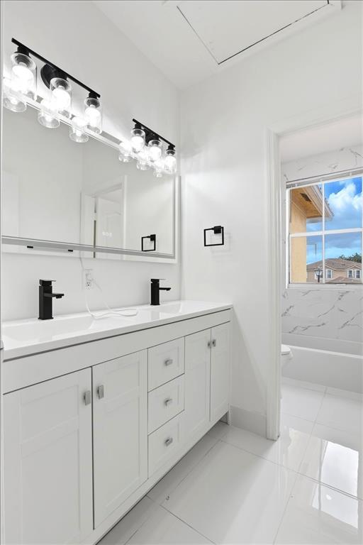 3802 Southwest 165th Terrace Miramar, FL 33027 - Photo 31 of 49 a spacious bathroom with double sink and a mirror