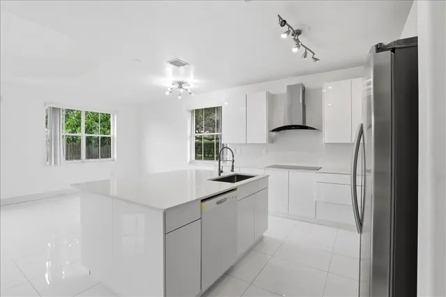a kitchen with a sink appliances and cabinets