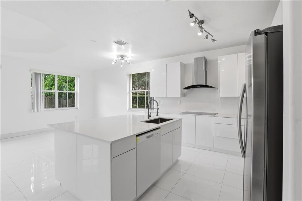 3802 Southwest 165th Terrace Miramar, FL 33027 - Photo 6 of 49 a kitchen with a sink appliances and cabinets