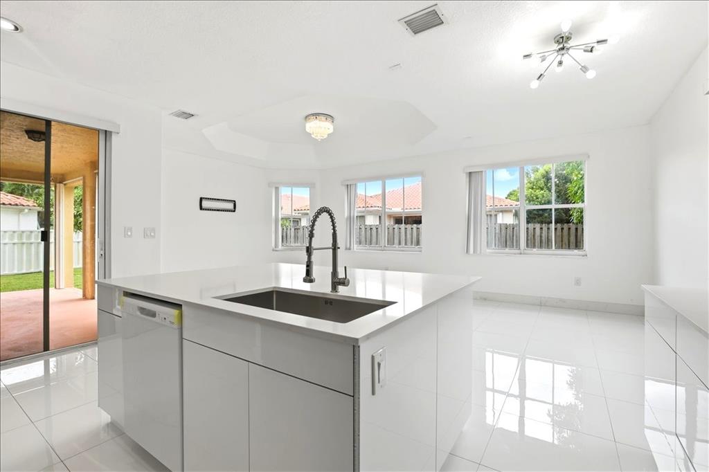 3802 Southwest 165th Terrace Miramar, FL 33027 - Photo 7 of 49 a kitchen with a sink and a window