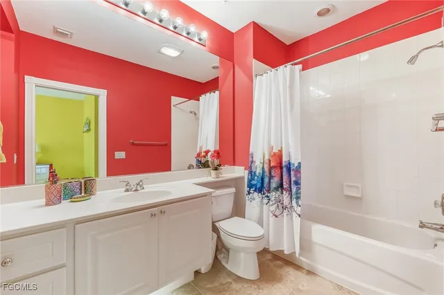 a bathroom with a double vanity sink toilet mirror and bathtub