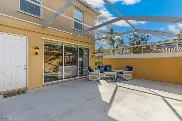 a view of a patio with a table and chairs and potted plants