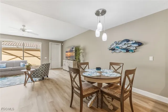 a dining room with furniture a chandelier and wooden floor