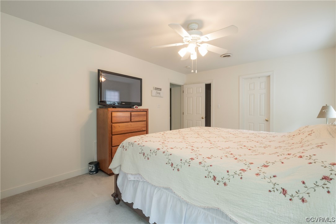 3530 Timberview Road Powhatan, VA 23139 - Photo 21 of 50 a bedroom with a bed and a chandelier