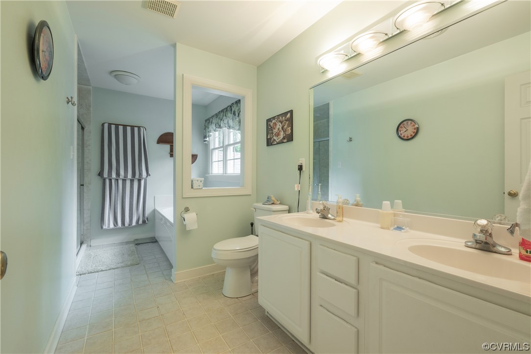 3530 Timberview Road Powhatan, VA 23139 - Photo 23 of 50 a spacious bathroom with a double vanity sink a mirror and a toilet