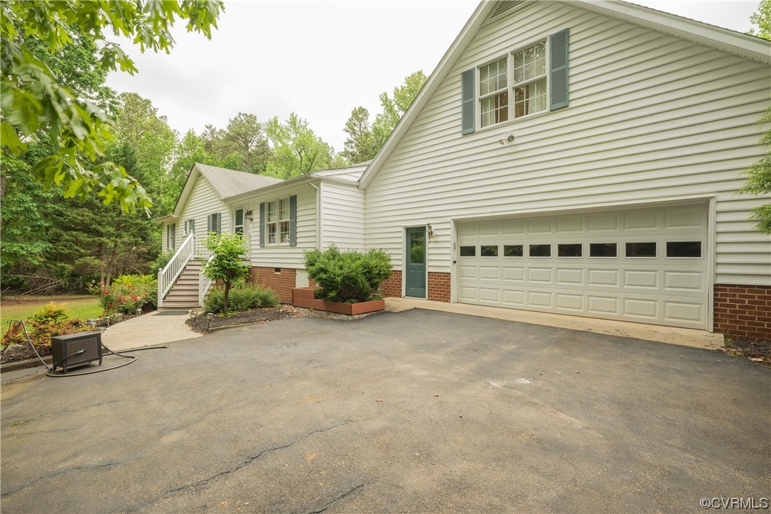 3530 Timberview Road Powhatan, VA 23139 - Photo 3 of 50 a view of a house with a yard and garage