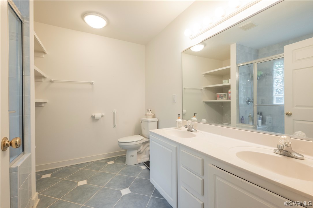 3530 Timberview Road Powhatan, VA 23139 - Photo 36 of 50 a bathroom with a double vanity sink toilet and shower