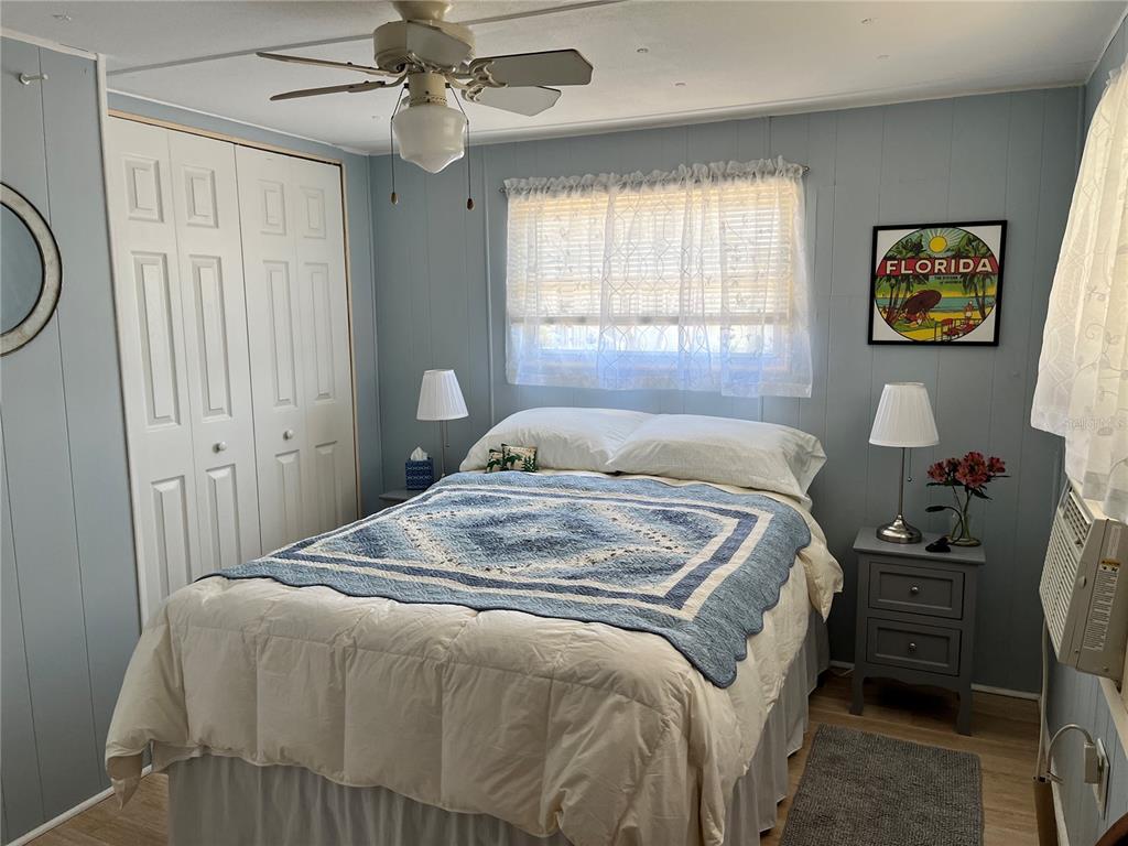 7254 Mt Fairfield Road Northeast, Unit 531 St. Petersburg, FL 33702 - Photo 11 of 19 a bedroom with a bed and a chandelier