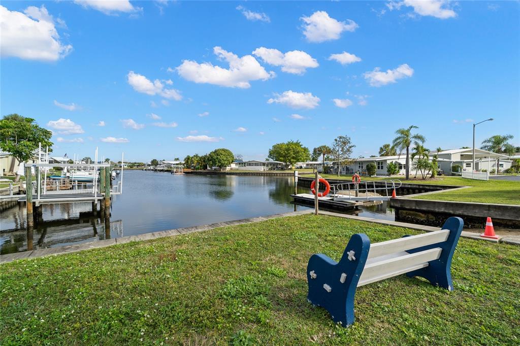 7254 Mt Fairfield Road Northeast, Unit 531 St. Petersburg, FL 33702 - Photo 16 of 19 a view of a lake with couches chairs and a table and chairs