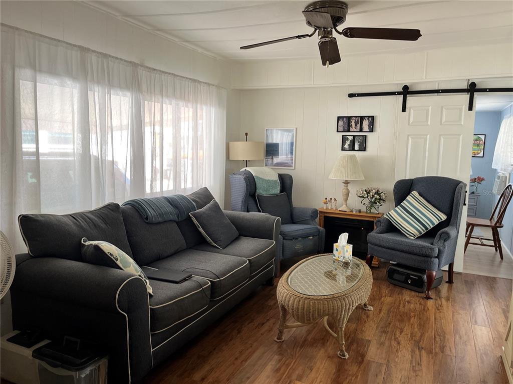 7254 Mt Fairfield Road Northeast, Unit 531 St. Petersburg, FL 33702 - Photo 4 of 19 a living room with furniture and a window