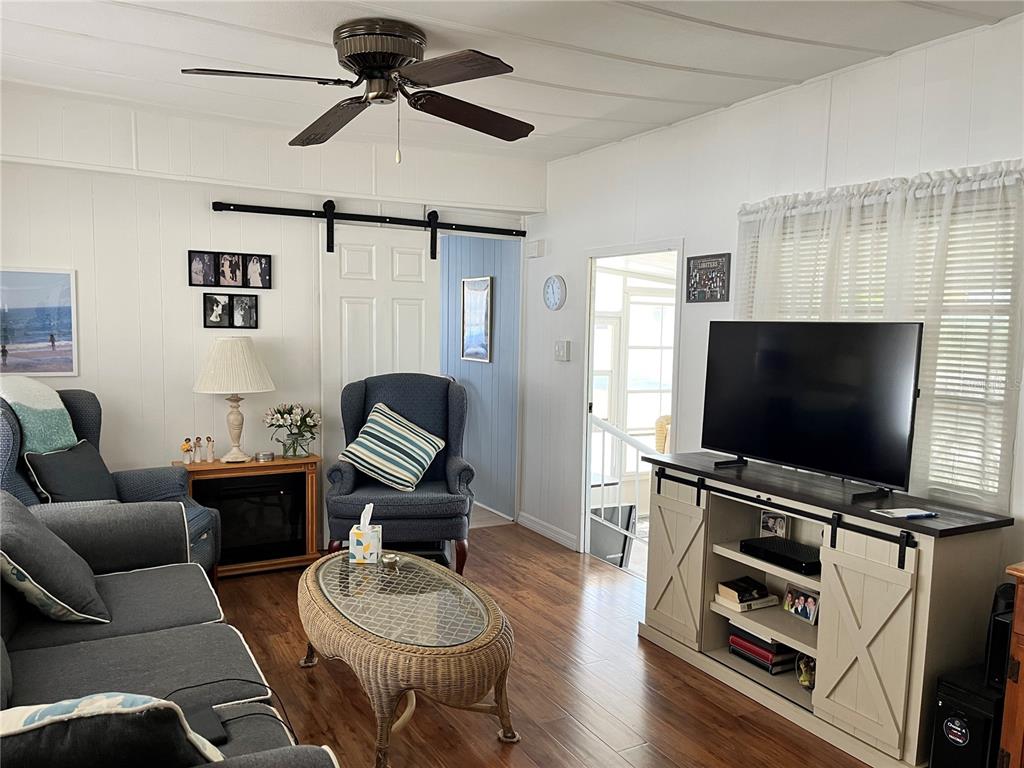 7254 Mt Fairfield Road Northeast, Unit 531 St. Petersburg, FL 33702 - Photo 5 of 19 a living room with furniture and a flat screen tv