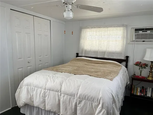 a bedroom with a bed and a window