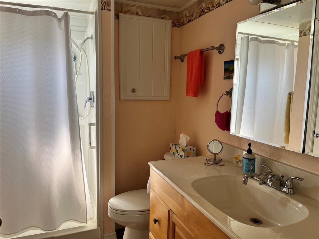 7254 Mt Fairfield Road Northeast, Unit 531 St. Petersburg, FL 33702 - Photo 10 of 19 a bathroom with a sink toilet and shower