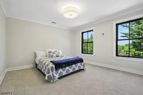 a spacious bedroom with a bed and window