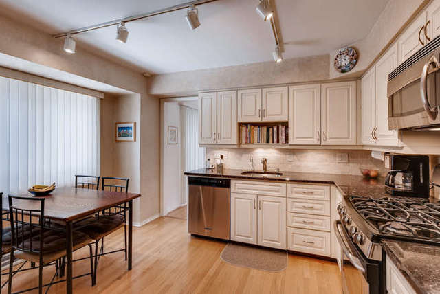 93 Ellendale Road Deerfield, IL 60015 - Photo 8 of 21 a kitchen with stainless steel appliances granite countertop a stove top oven a sink dishwasher and white cabinets with wooden floor