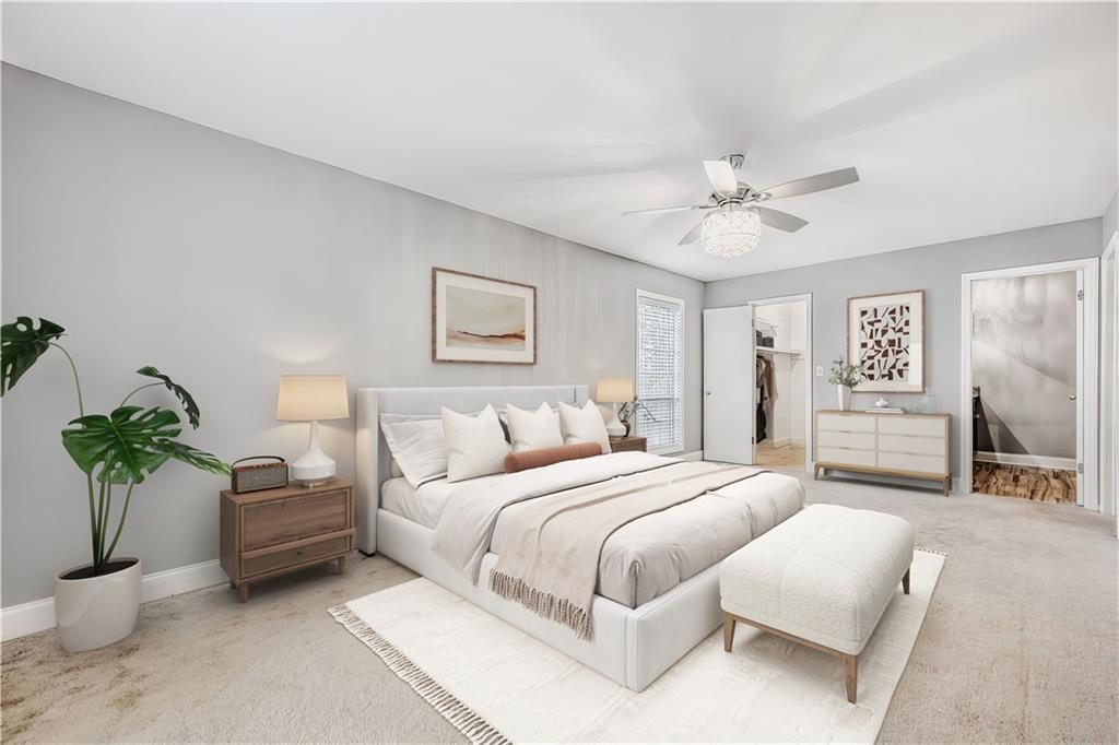 6851 Roswell Road, Unit A5 Atlanta, GA 30328 - Photo 11 of 35 a bedroom with a bed and a chandelier