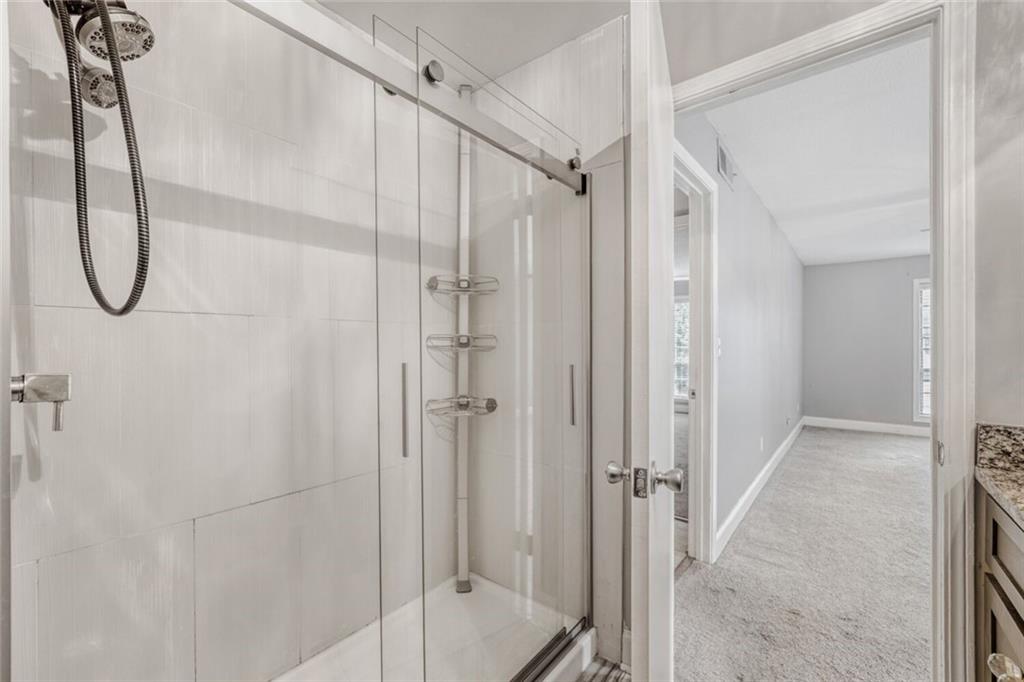 6851 Roswell Road, Unit A5 Atlanta, GA 30328 - Photo 14 of 35 a bathroom with a glass shower door