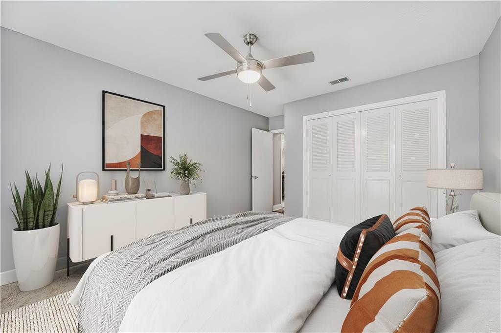 6851 Roswell Road, Unit A5 Atlanta, GA 30328 - Photo 17 of 35 a bedroom with a bed and a potted plant