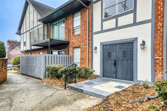 a view of a house with a small yard and plants