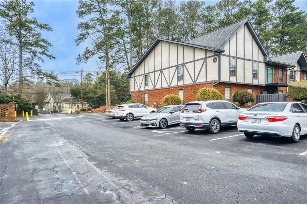 6851 Roswell Road, Unit A5 Atlanta, GA 30328 - Photo 24 of 35 a view of cars parked in front of a house