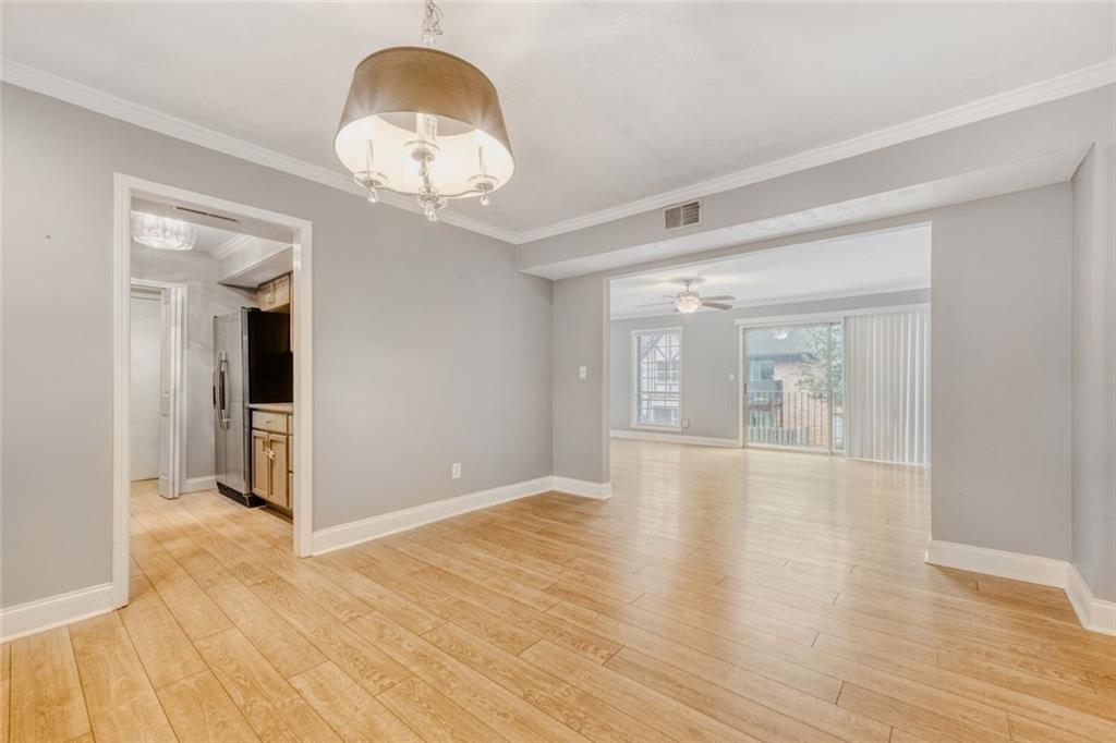 6851 Roswell Road, Unit A5 Atlanta, GA 30328 - Photo 28 of 35 wooden floor in an empty room with a mirror