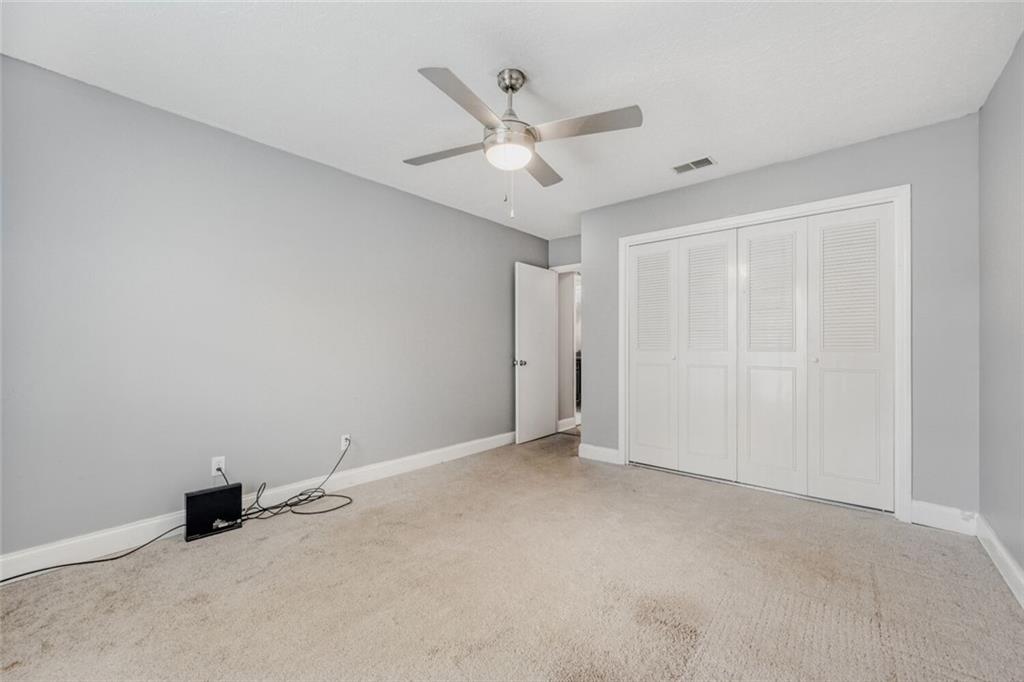 6851 Roswell Road, Unit A5 Atlanta, GA 30328 - Photo 35 of 35 an empty room with ceiling fan and window