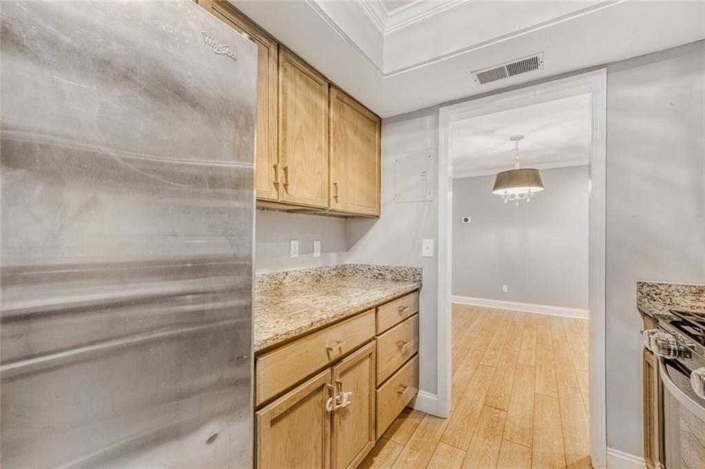 6851 Roswell Road, Unit A5 Atlanta, GA 30328 - Photo 6 of 35 a bathroom with a granite countertop sink and a mirror