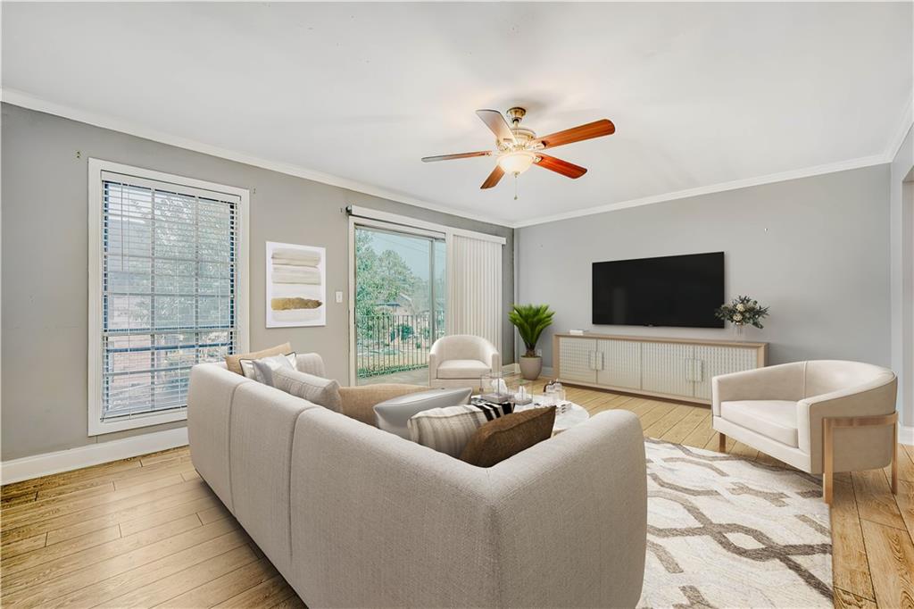 6851 Roswell Road, Unit A5 Atlanta, GA 30328 - Photo 7 of 35 a living room with furniture and a flat screen tv