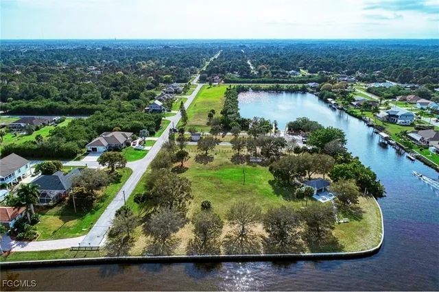 an aerial view of residential houses with outdoor space and lake view
