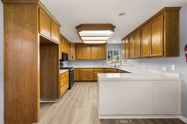 a kitchen sink with a granite countertop window and sink