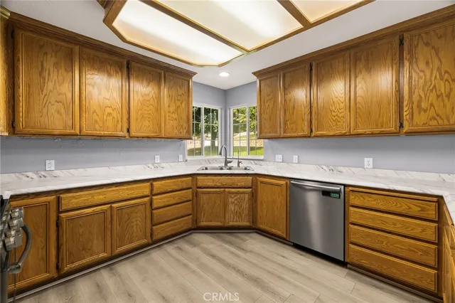 a kitchen with stainless steel appliances a stove a microwave and wooden floor