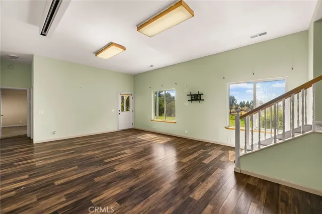 a view of balcony with a large window and wooden fence