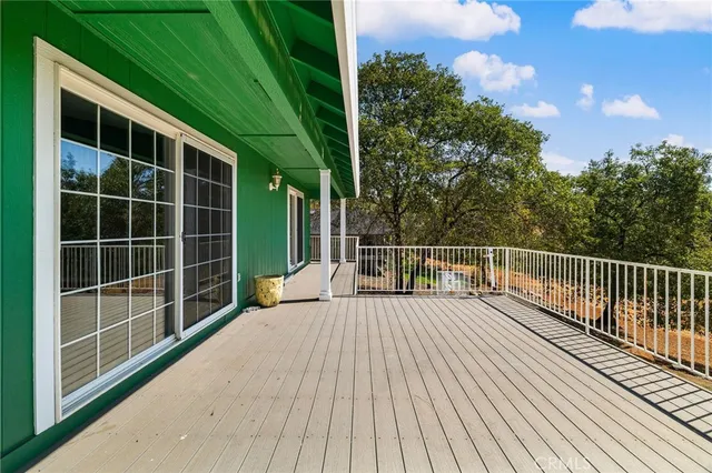 a view of a patio with a table chairs and a backyard