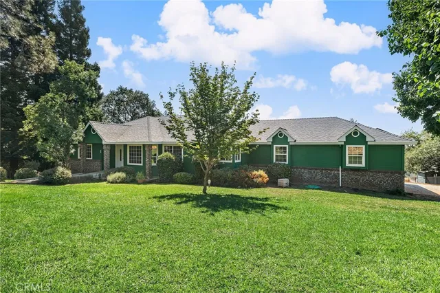 a view of a house with a yard and tree s