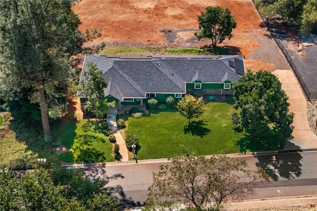 a front view of a house with a yard and a garage