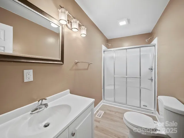 a bathroom with a sink a toilet a mirror and vanity