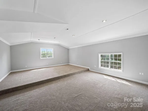 an empty room with a empty space and windows
