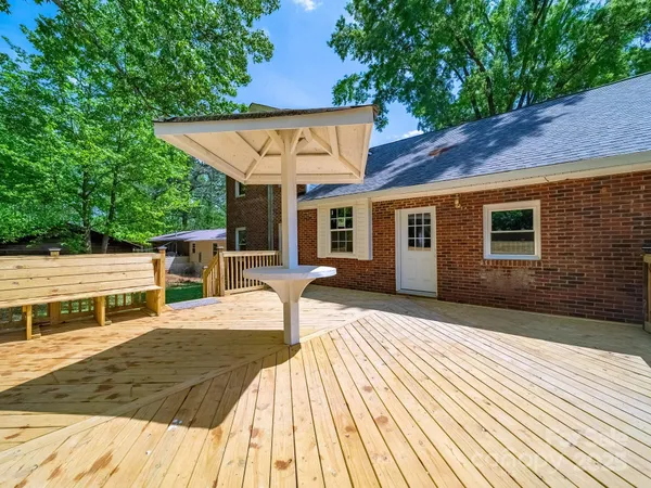 a view of a patio with table and chairs with wooden floor and fence
