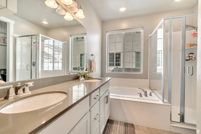 3232 West 1670th Street North Provo, UT 84601 - Photo 15 of 33 Full bath with a stall shower, double vanity, a bath, and suspended lighting