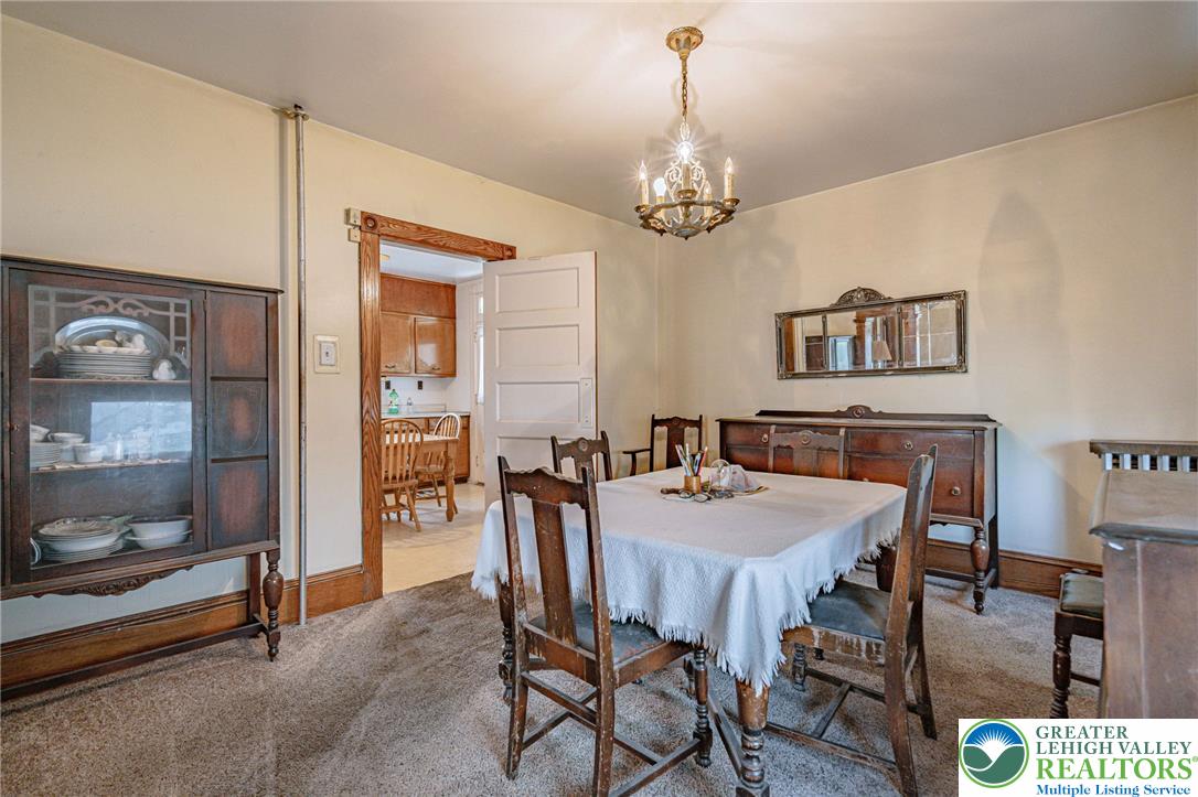 159 West Ridge Street Nesquehoning, PA 18240 - Photo 12 of 55 An inviting dining area features a classic chandelier and warm, neutral tones.