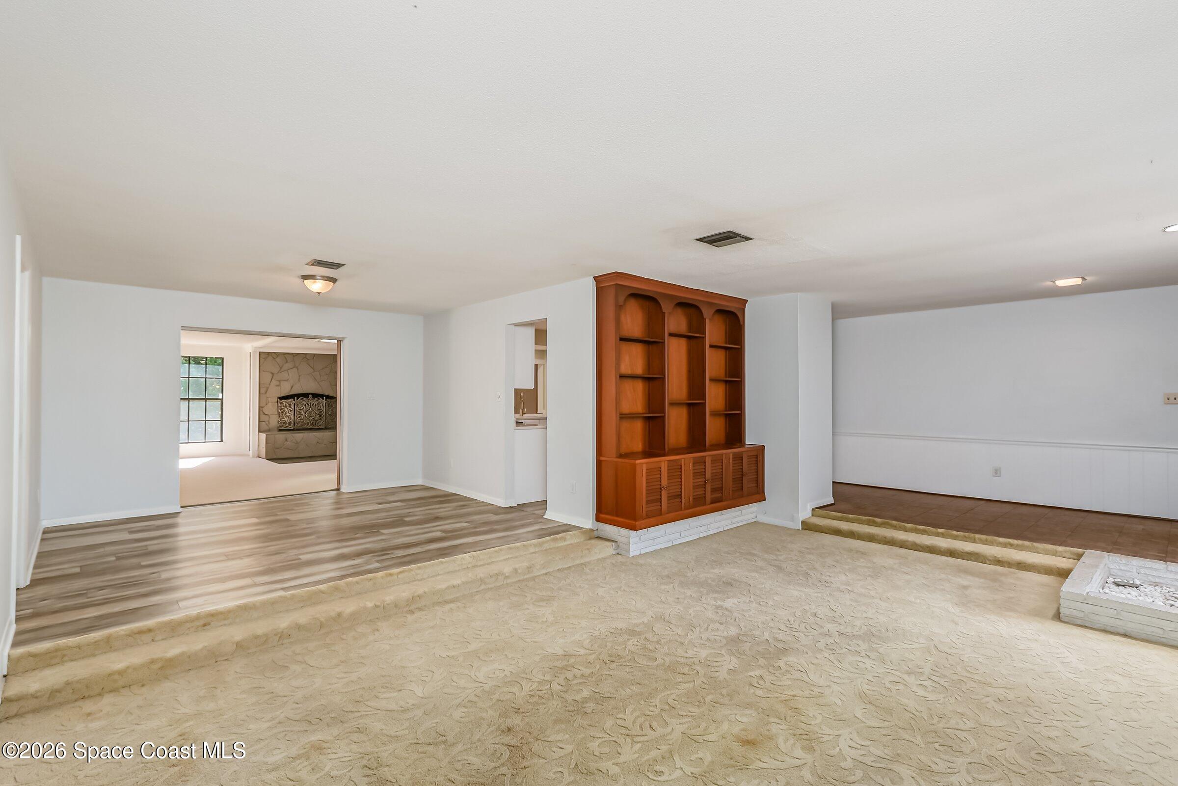 1275 Troon Way Rockledge, FL 32955 - Photo 17 of 62 Sunken LR to Dining Room